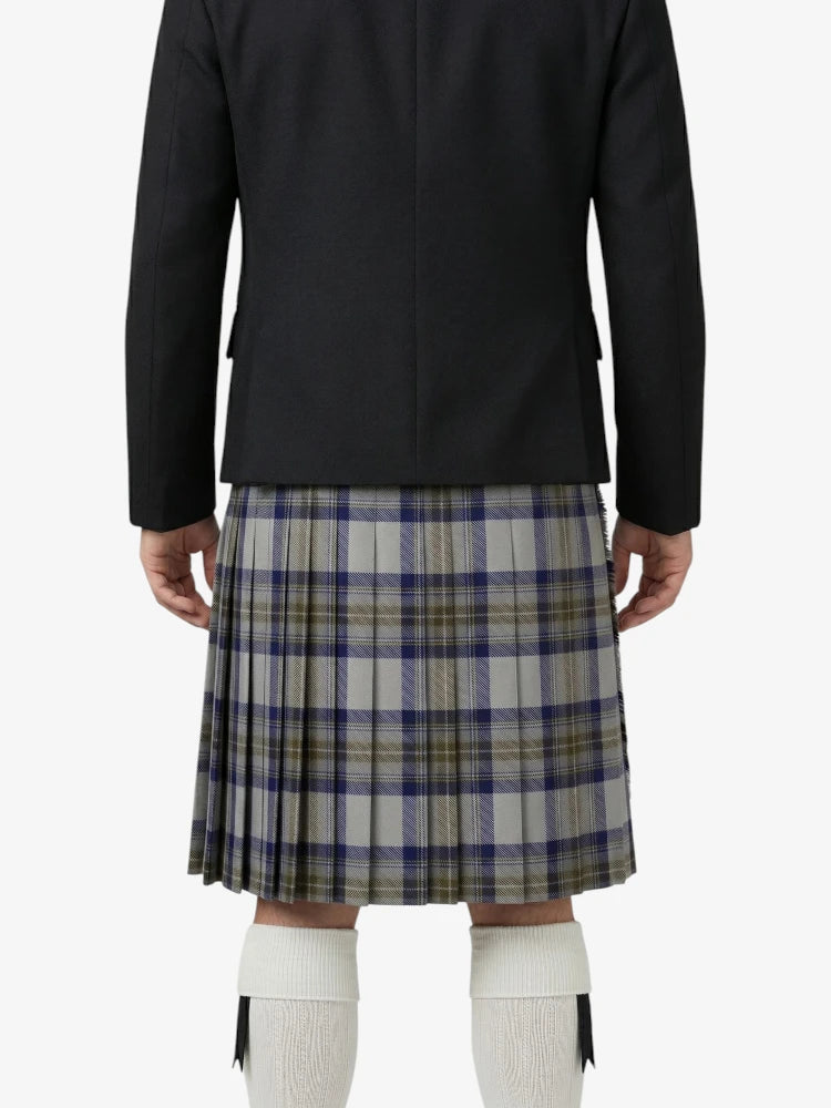 Person wearing a black jacket and plaid kilt on a white background