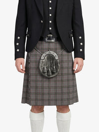 Person wearing a black jacket with decorative buttons and a gray plaid kilt on a white background