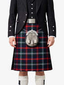 Person wearing a traditional Scottish kilt with a tartan pattern on a white background