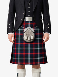Person wearing a traditional Scottish kilt with a tartan pattern on a white background