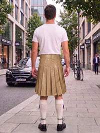 A man viewed from behind wearing a white t-shirt and a pleated tan leather kilt, standing on a city sidewalk with a street, car, and bicycle in the background.