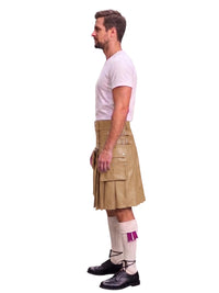 A man shown in profile wearing a tan leather kilt, a white t-shirt, white socks with a purple accent, and black shoes, photographed against a solid white background.