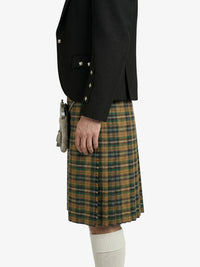 Person wearing a black jacket and plaid kilt on a white background