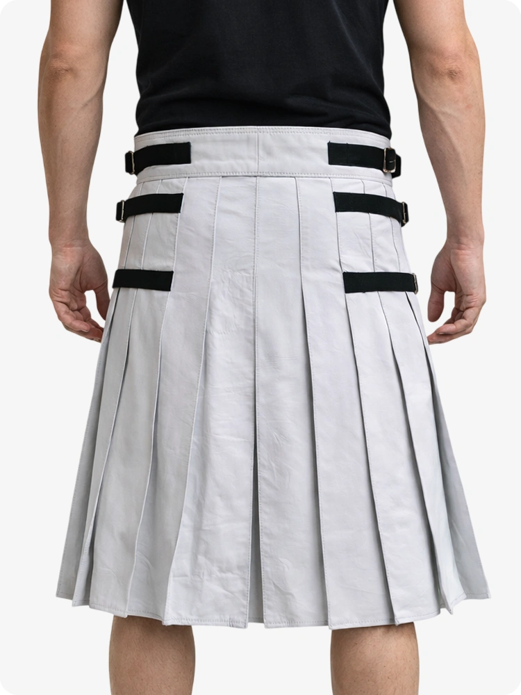 White pleated skirt with black straps worn by a person on a white background