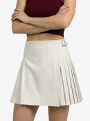 Person wearing a white pleated skirt with a belt on a white background