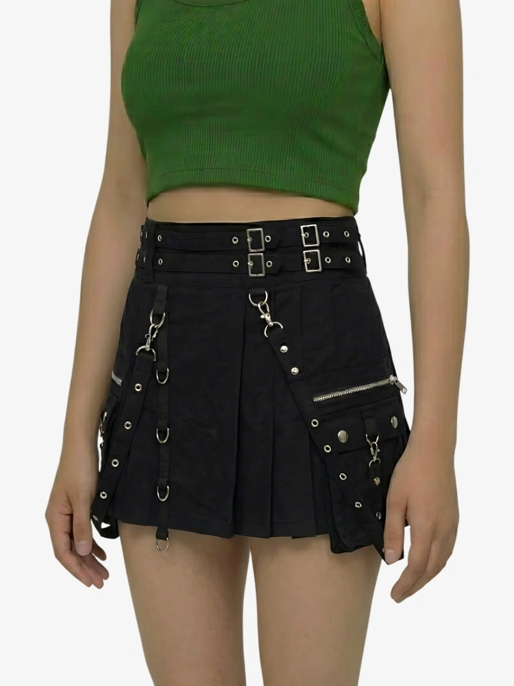 Person wearing a green crop top and black skirt with metal accents on a white background