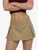 Person wearing a beige skirt with gold buttons on a white background