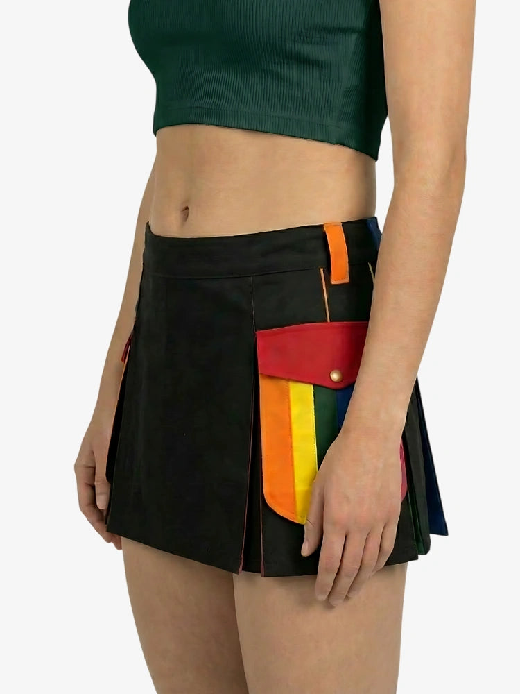 Black skirt with colorful patchwork design worn by a person on a white background