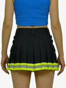 Black pleated skirt with reflective yellow strip worn by a person on a white background