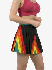 Person wearing a colorful skirt with rainbow design on a white background