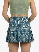 Blue camouflage skirt worn by a person on a white background