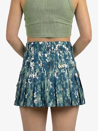 Blue camouflage skirt worn by a person on a white background