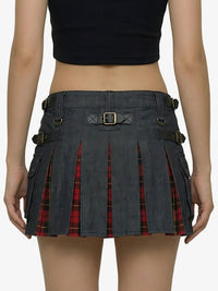 Black pleated skirt with red plaid pattern worn by a model on a white background