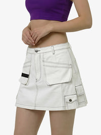 White cargo skirt worn by a person on a white background