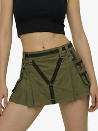 Person wearing a green skirt with black suspenders on a white background