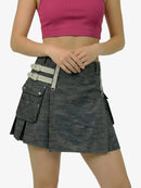 Person wearing a gray kilt with silver buckles on a white background