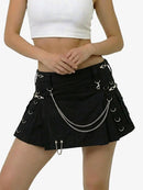 Black skirt with chain details worn by a person on a white background