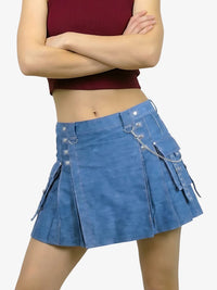 Person wearing a blue denim skirt with decorative elements on a white background