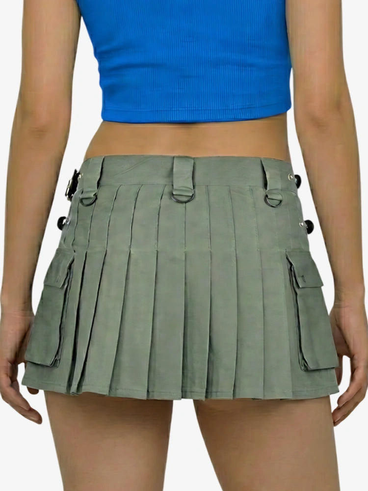 Person wearing a green pleated skirt and blue top on a white background