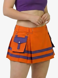 Person wearing an orange skirt with purple accents on a white background