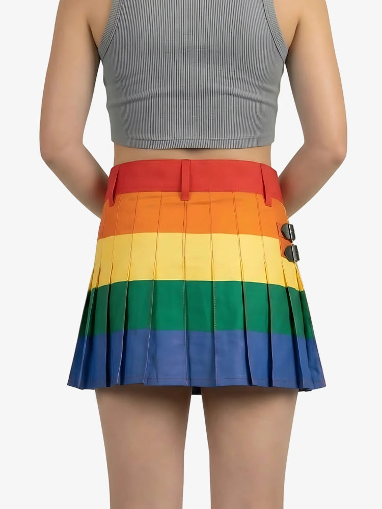 Person wearing a rainbow pleated skirt with a plain background