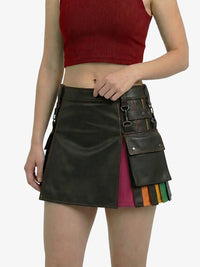 Person wearing a black leather skirt with colorful accents on a white background