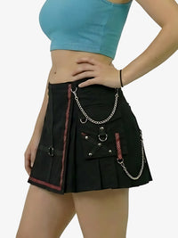 Black skirt with chain details worn by a person on a white background