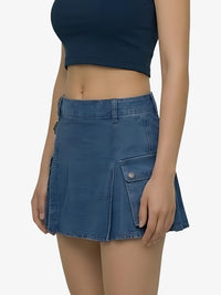Person wearing a blue denim skirt on a plain background