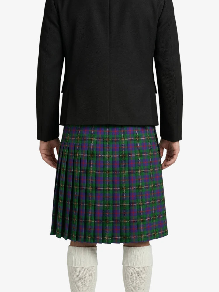 Person wearing a black jacket and green plaid kilt on a white background