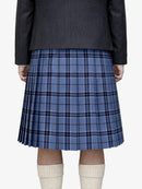 Person wearing a blue plaid kilt with a dark jacket on a white background